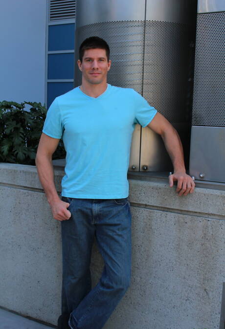 Bodybuilder Jake Bane shows a muscle body outdoor